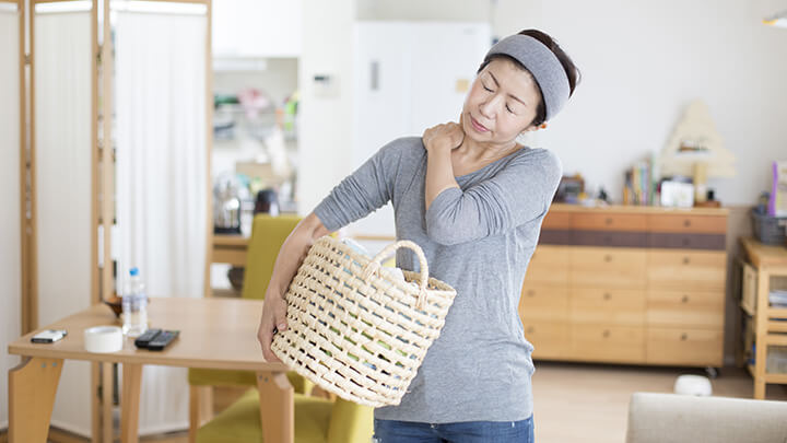 Woman doing laundry having back aches